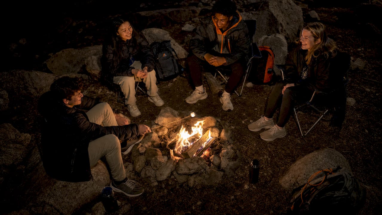 best southwesterntravel.com alternatives for groups in 2026 3 students enjoying southwestern desert campfire at night