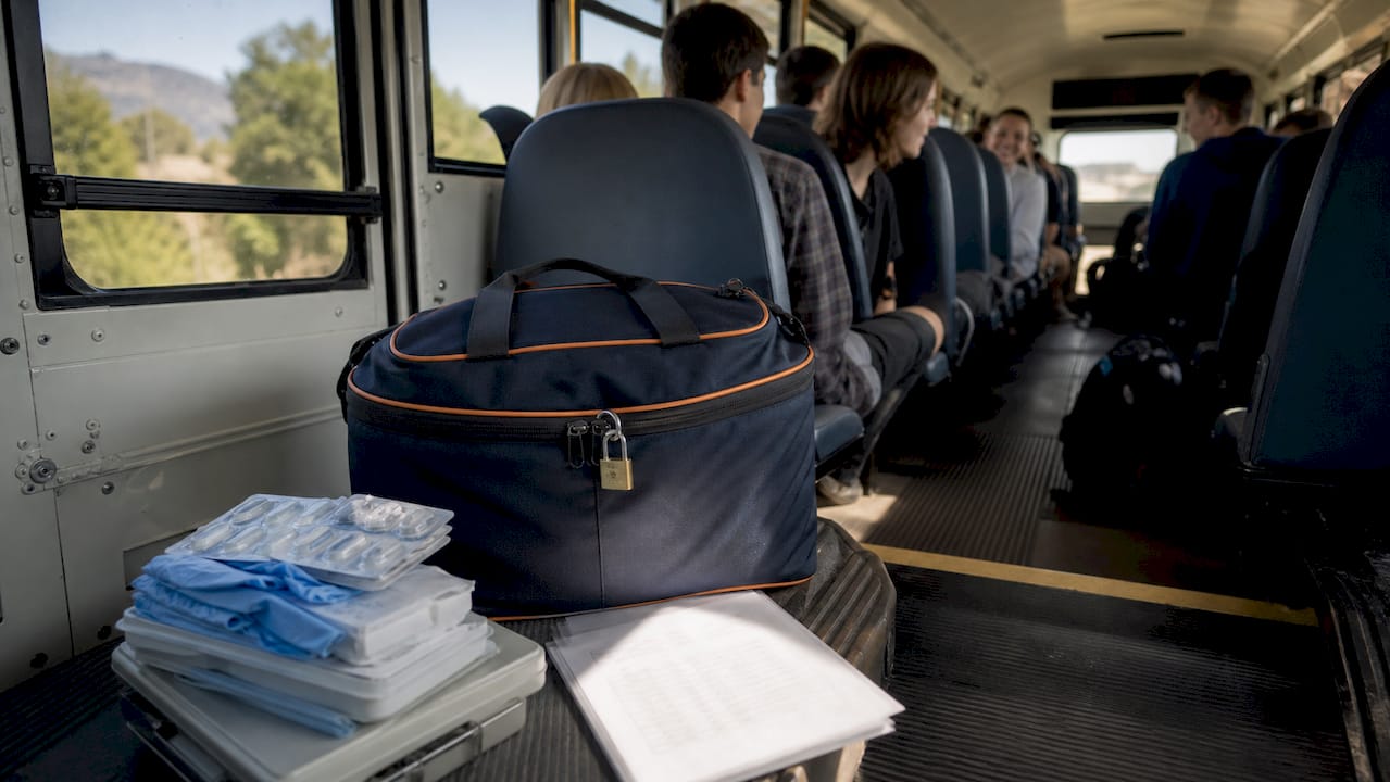 secured emergency medical kit on bus seat